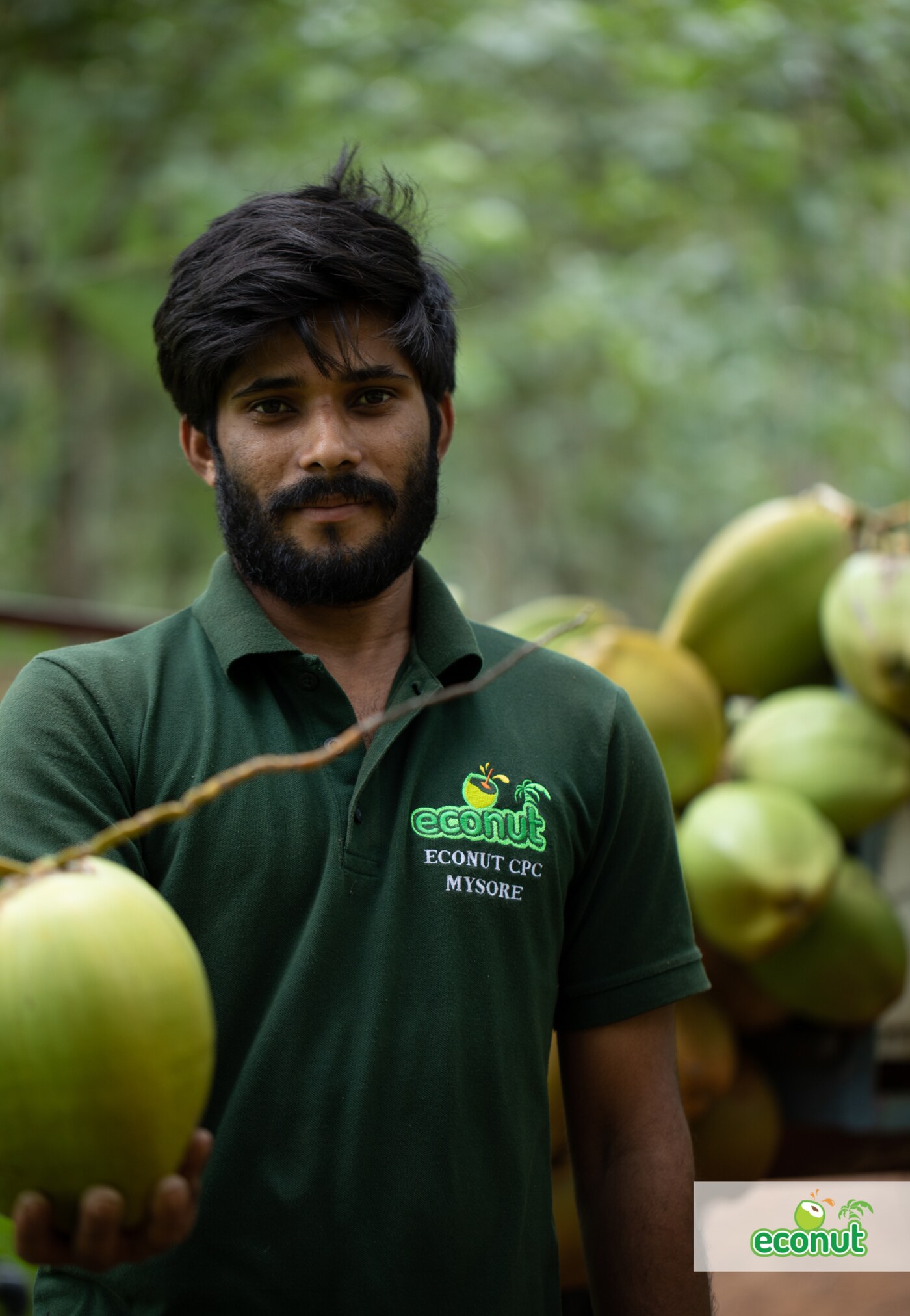 ECONUT farmer standing with freshly harvested tender coconuts